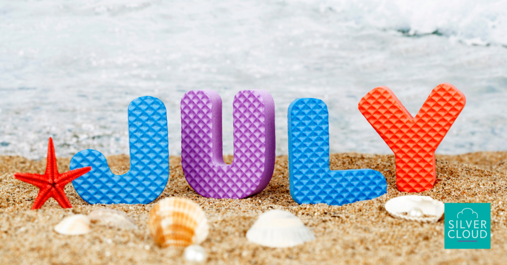 A beach with foam letters spelling july to introduce the hr tech news for july 2024.