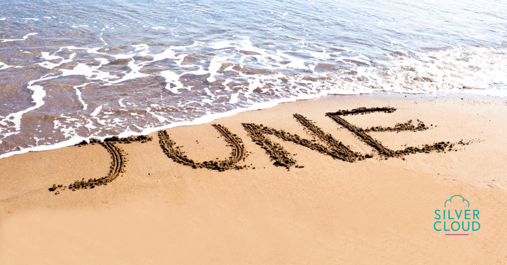 A picture of a wave crashing on the sand in which the word June is written