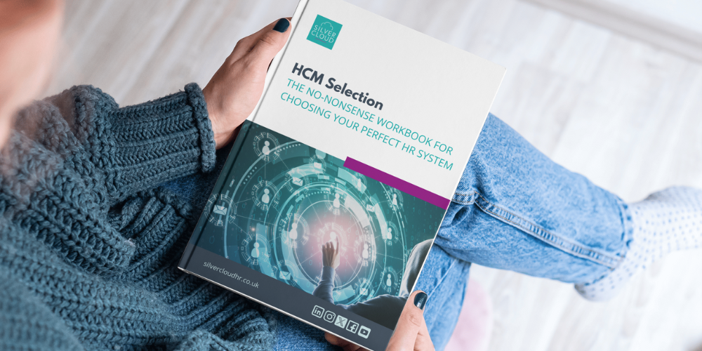 HR leader holding the ultimate HCM selection workbook preparing for their HR tech transformation project